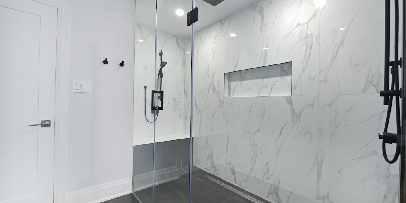 Modern marble bathroom with glass shower enclosure